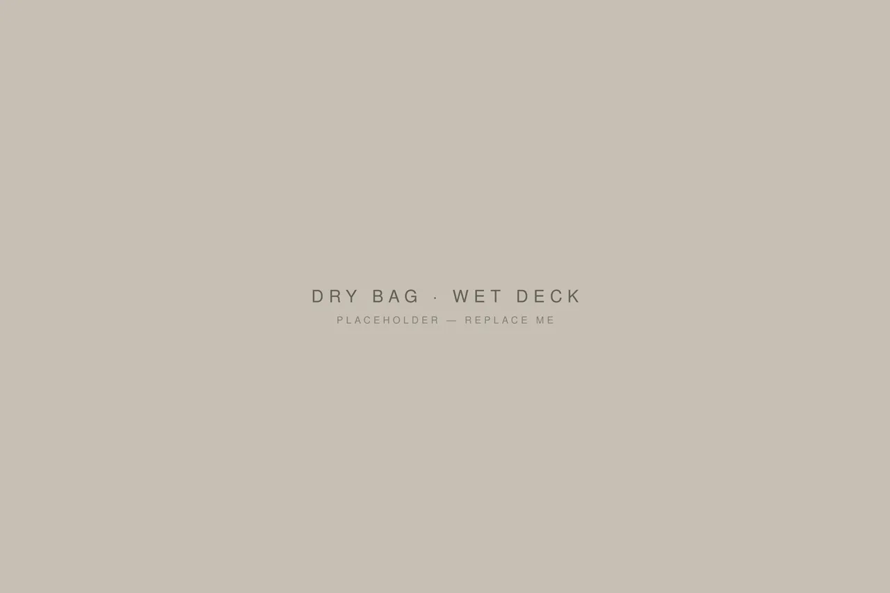 A roll-top dry bag sitting on a wet boat deck.
